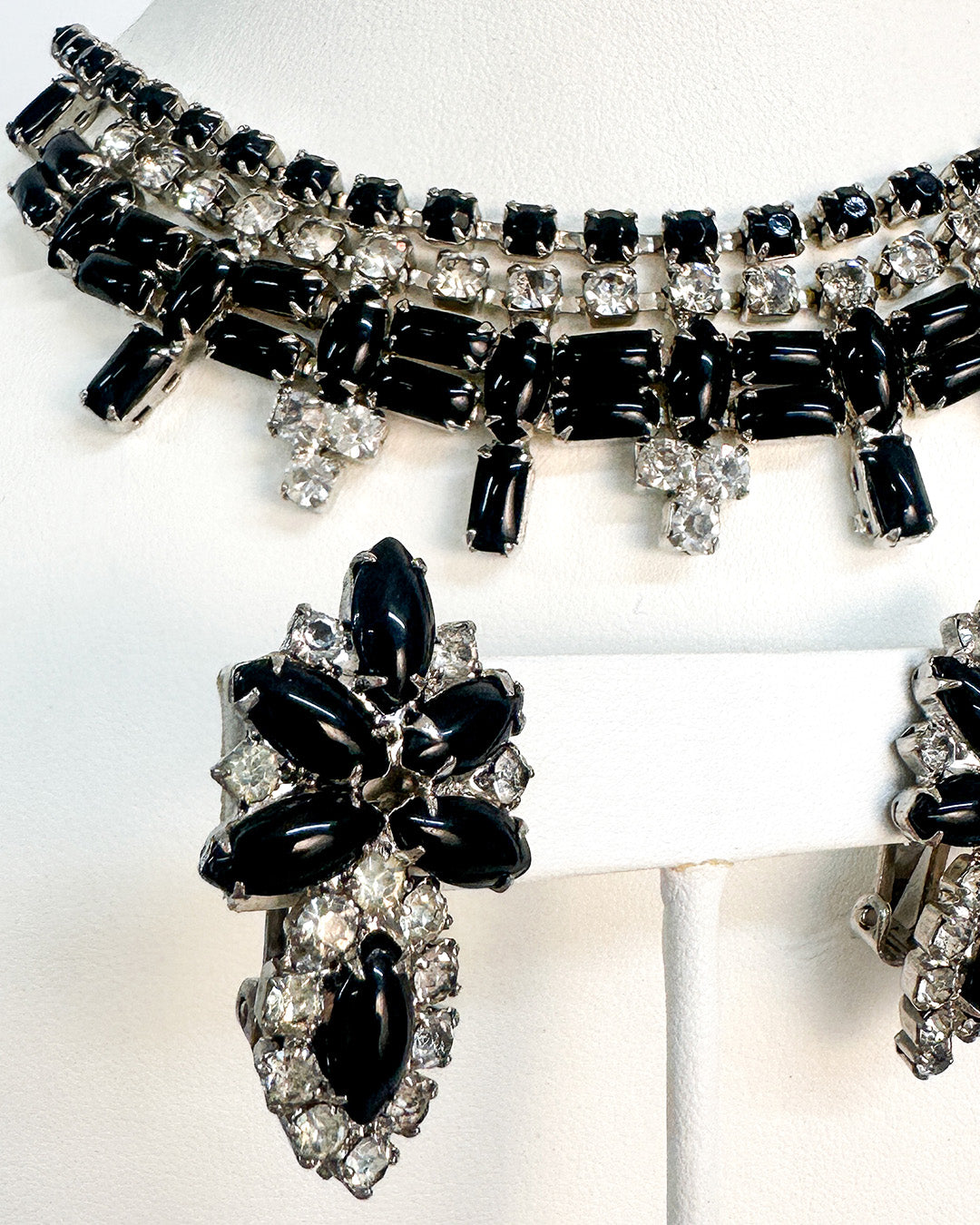 Black and silver jewelry set on a white background