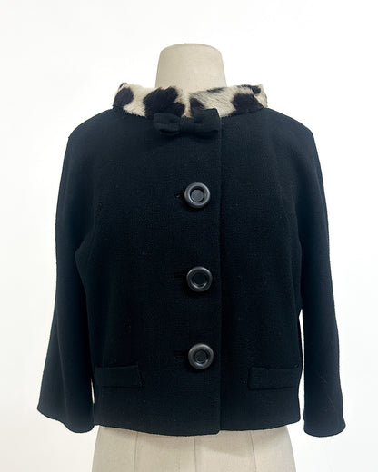 black coat with fur-lined hood on a mannequin against a white background