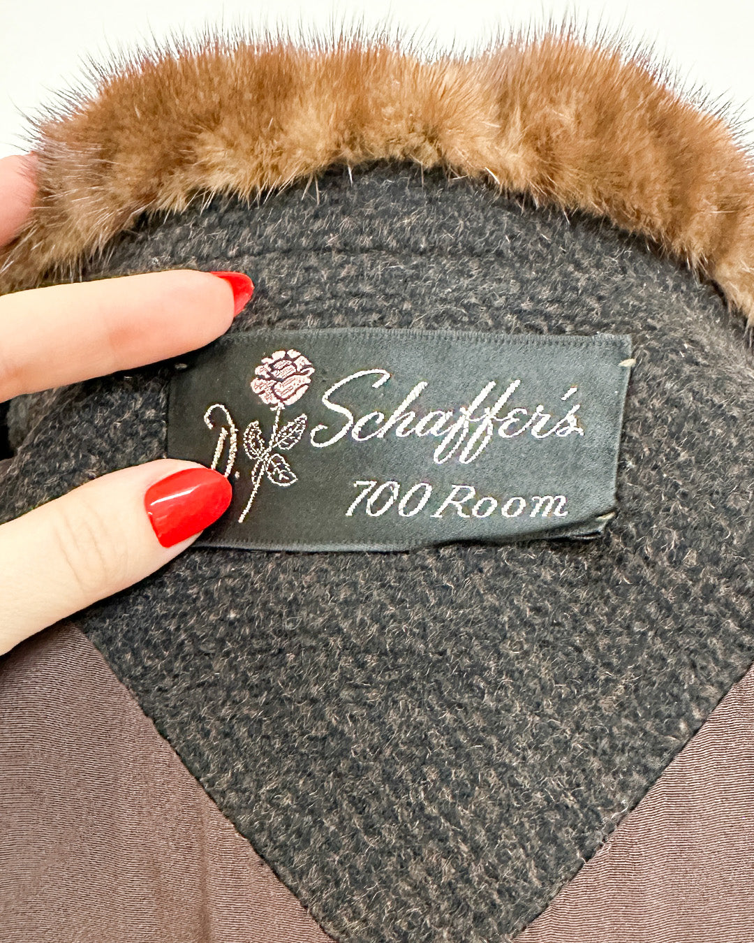 Label on a fur-trimmed item with 'Schaffer's 700 Room' branding.